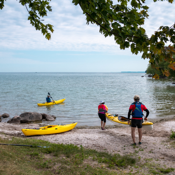 Group of people with kayaks at the waters edge