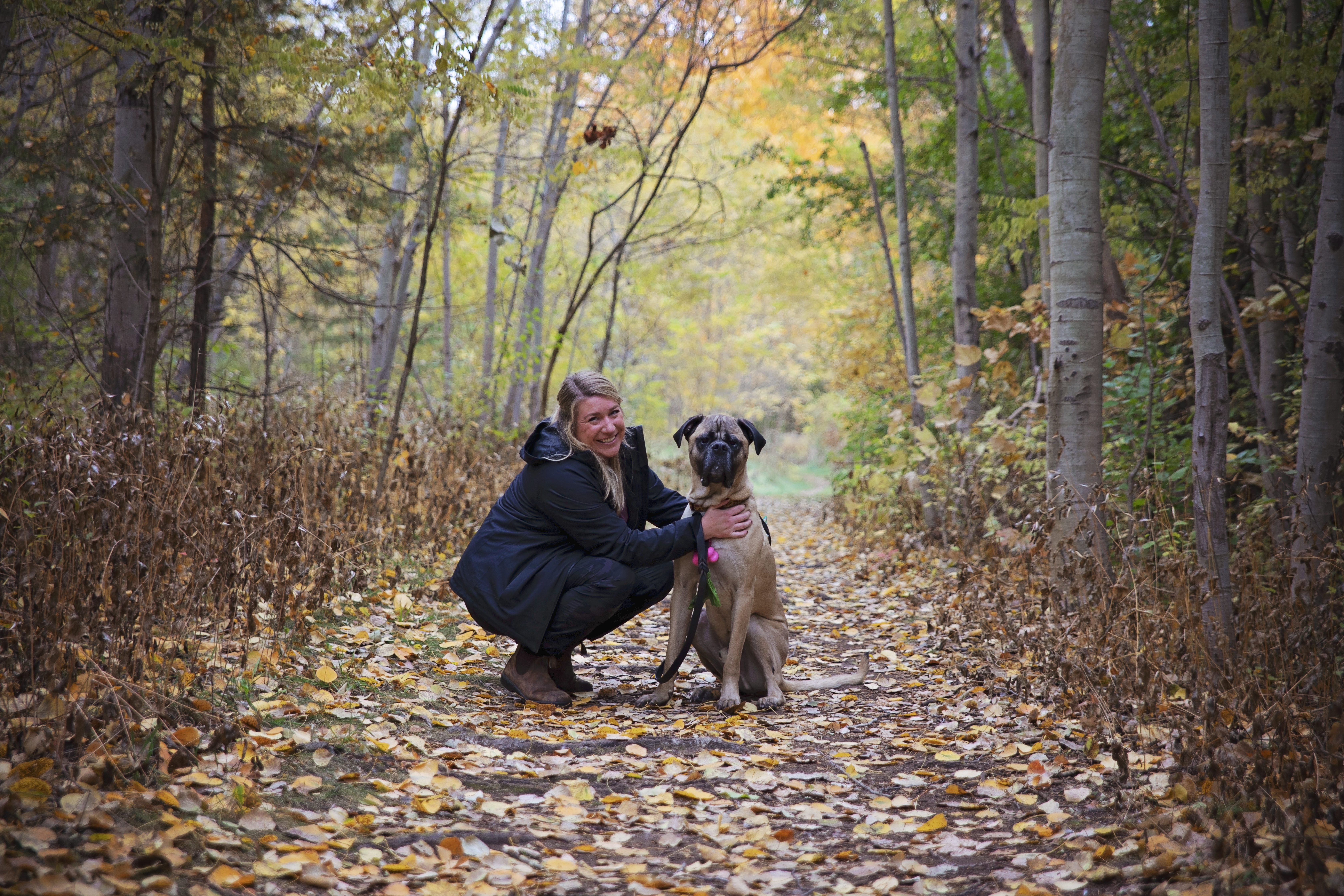 woman on fall trail with dog