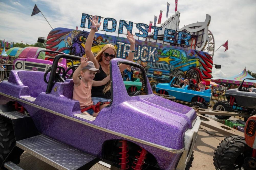 young woman and child enjoying fair ride at Sutton Fair