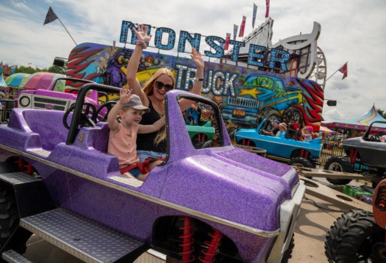 young woman and child enjoying fair ride at Sutton Fair