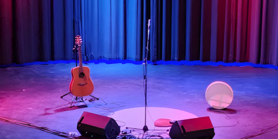 Empty stage with a guitar and drum on stage