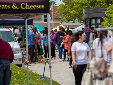people walking among tents at a farmers market