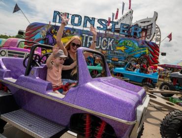 young woman and child enjoying fair ride at Sutton Fair