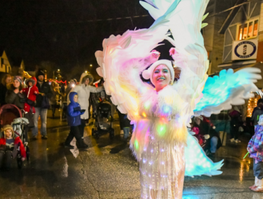 lady in light up costume dancing with children
