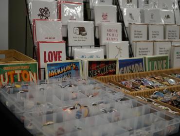table at a fair with pins and printed items