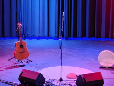 Empty stage with a guitar and drum on stage